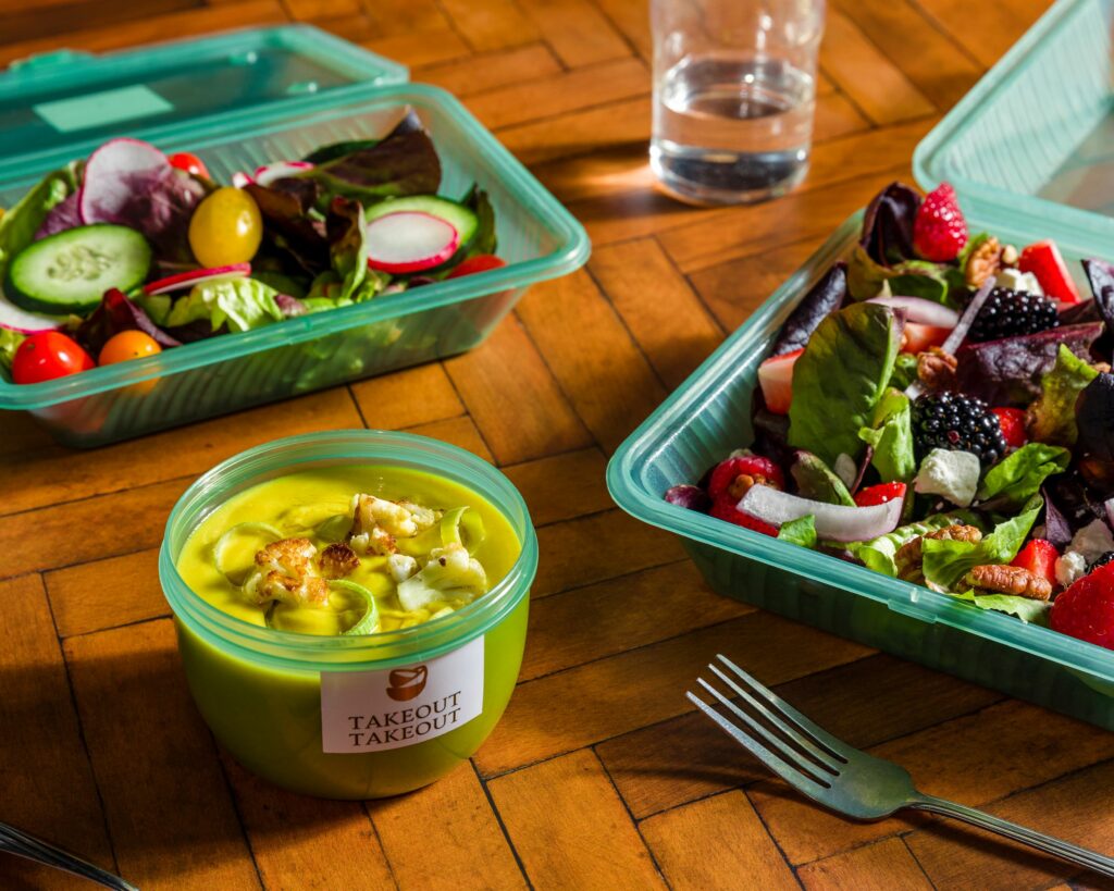 Takeout Takeout of Michigan reusable containers with soup and salad inside